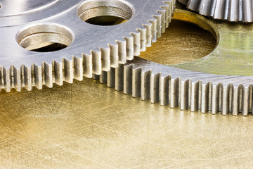 parts of industrial machines closeup. metal gear cogwheels on scratched background.