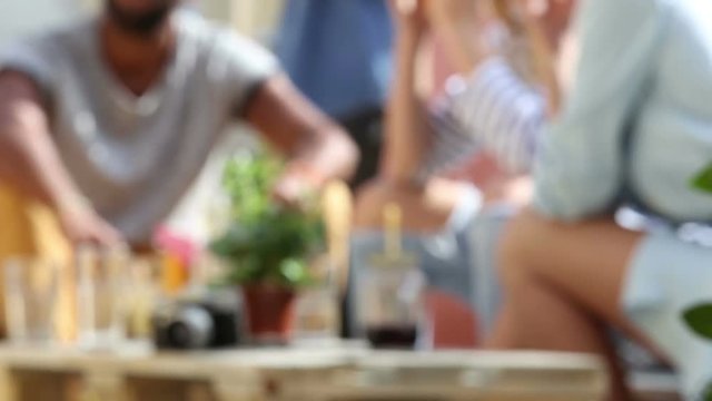 Blurred shot of table with cocktails at rooftop party