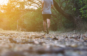 Athlete runner feet running on trail.