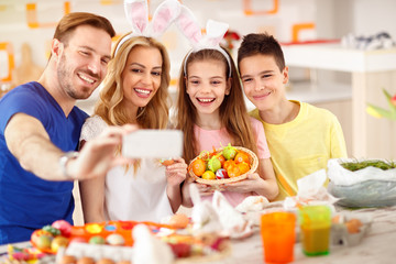 Family make selfie with basket of Easter eggs