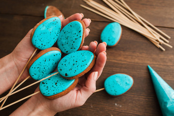 Homemade easter cake pops with blue icing on rustic wooden table top view