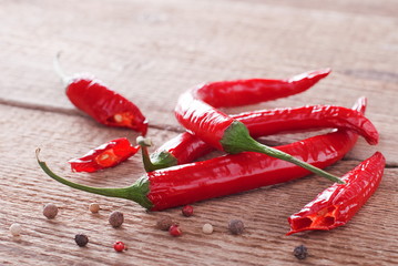 few spicy red peppers on an old board