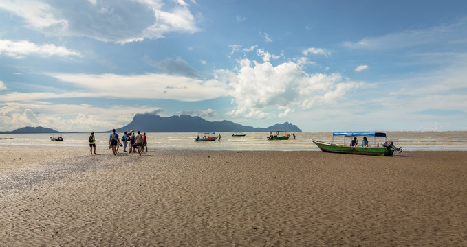 People walking on the beach to get to the boats to return from Bako National Park in Borneo