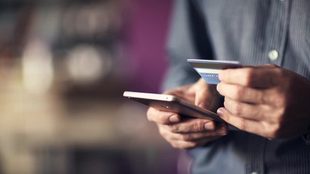 Online banking. A man makes an internet payment using a smartphone.
