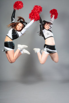 Two Cheerleaders Jumping