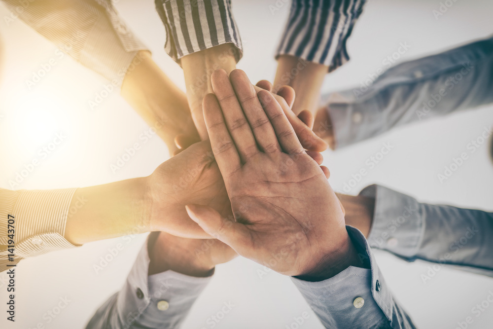 Aufkleber hands stacked in a pile. a symbol of teamwork and trust.