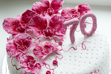 sweet pink orchids white anniversary cake closeup