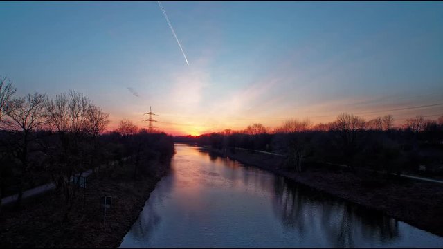 Sundown over river with passing ship