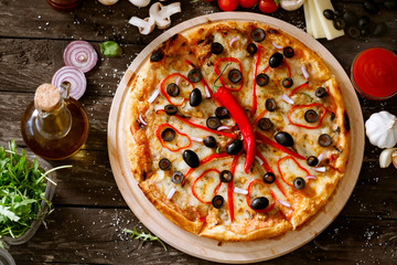 Cheese pizza with fresh ingredients on table.