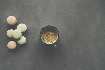 Macaron and coffee on cement background
