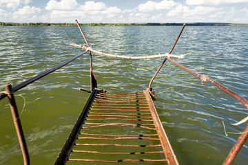 Old rusty metal bridges on the lake.