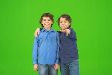 The two little twin gesture on the green background