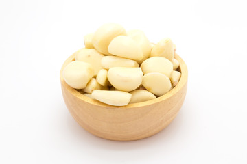 Fresh garlic on wooden bowl, on white background