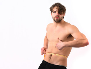 Caucasian sexy young macho uses measuring tape