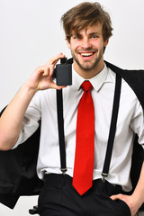 Naklejka premium Caucasian stylish man posing with perfume