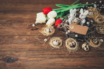 Easter decoration background. Quail eggs in nest with tag 
