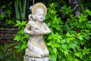 Fototapeta premium Girl statue in white stone in Balinese style