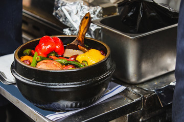 Bell pepper and hot pepper in the cook's pan.  chef  cooking fast food on a city street