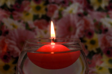 Floating candle on a floral spring background
