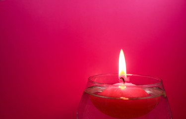 Floating candle on a bright colored background
