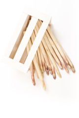 Bunch of white asparagus spears in a box, on white background