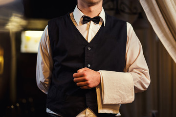 Waiter served table in the restaurant before the feast,Waiter in uniform waiting an order,Waiter...