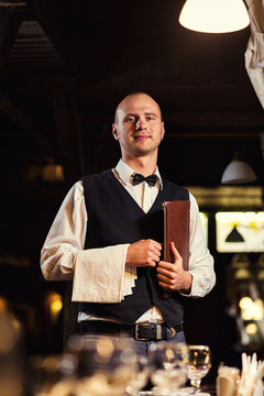 Waiter in uniform waiting an order,waiter order menu,Waiter with a white towel on his hand