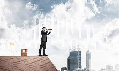 Engineer man standing on roof and looking in spyglass. Mixed med