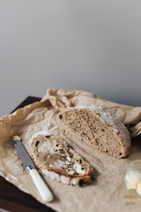Sliced Walnut Bread on Table with Knife and Butter