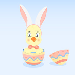 A chicken in a hoop with ears like a rabbit sits in the Easter egg