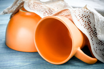 eramic cup and plate with an openwork linen napkin on a wooden background. Kitchen Decor in Rustic...