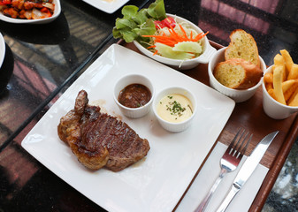 Grilled steak with french fries and vegetables