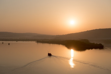 Tropical sunrise over misty river