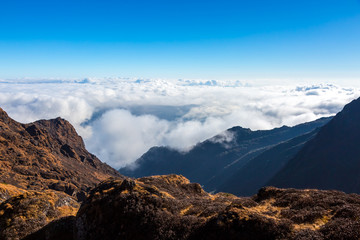 Fototapeta premium Mountain Valley and Layer of Clouds below