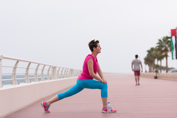 woman stretching and warming up on the promenade