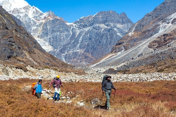 Hikers walking on Meadow in Mountain Valley mix ethnicity Team