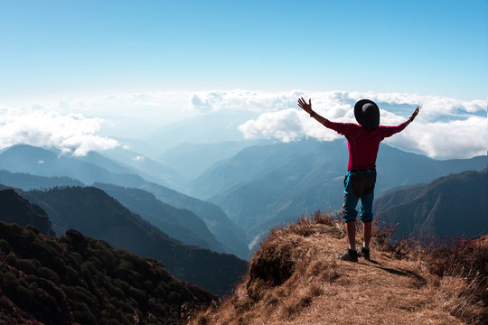 Ecstatic Person in Mountains embracing the World Gesture
