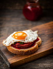 Vegetarian beetroot sandwich with egg, spinach and red chili jam