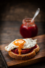 Vegetarian beetroot sandwich with egg, spinach and red chili jam