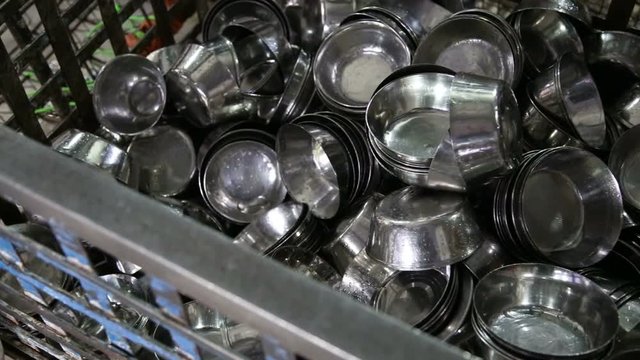 Pile of washed silver cups at public kitchen in Amritsar.