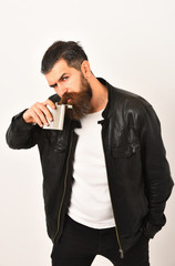 serious bearded man hipster with metallic jar in leather jacket