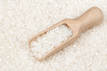 Fototapeta na wymiar scoop on white rice background