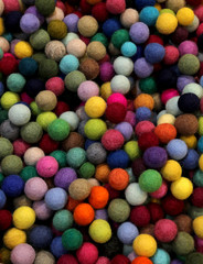 Fototapeta na wymiar background of multicolored felt balls