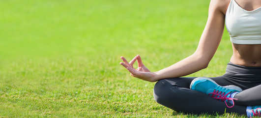 Young girl doing yoga in the park