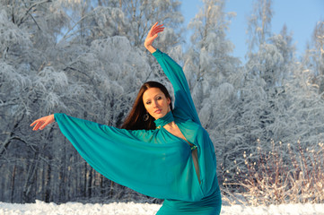 Girl dancing on the background of a winter landscape.