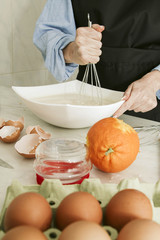 cook, whisking the ingredients in the bowl