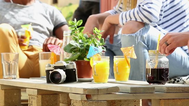 View of table full of colorful cocktails at rooftop party