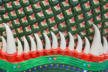 close-up tooth of naga statue in thai temple for background