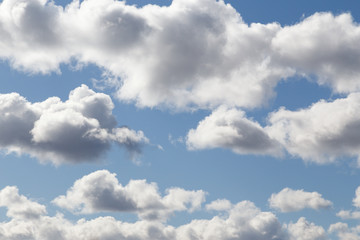 Naklejka na ściany i meble Fluffy clouds under the blue sky float