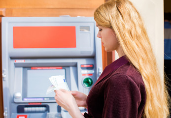 Fototapeta na wymiar Cash out money at an ATM